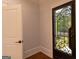 Welcoming foyer with decorative metal and glass front door and hardwood floors at 10765 Shallowford Rd, Roswell, GA 30075