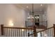 Open foyer with wooden staircase, black railings and chandelier at 10765 Shallowford Rd, Roswell, GA 30075