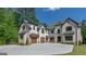Spacious home with a three-car garage and ample driveway space, perfect for car enthusiasts or large families at 10765 Shallowford Rd, Roswell, GA 30075