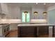 Modern kitchen featuring large island, stainless steel appliances, and custom cabinets at 10765 Shallowford Rd, Roswell, GA 30075