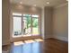 Living room with hardwood floors, large window and recessed lighting at 10765 Shallowford Rd, Roswell, GA 30075
