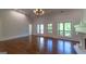 Spacious living room with hardwood floors, fireplace, coffered ceilings, and natural light at 10765 Shallowford Rd, Roswell, GA 30075