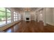 Expansive living room showcasing hardwood floors, a fireplace, large windows, and access to outdoor space at 10765 Shallowford Rd, Roswell, GA 30075