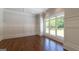 Living room with hardwood floors, large window, wainscoting, and recessed lights at 10765 Shallowford Rd, Roswell, GA 30075