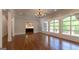 Open living room featuring hardwood floors, coffered ceilings, decorative molding, and large windows at 10765 Shallowford Rd, Roswell, GA 30075