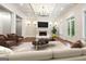 Inviting living room featuring a fireplace, modern furniture, and plenty of natural light, ideal for relaxation and entertaining at 10765 Shallowford Rd, Roswell, GA 30075