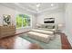 This main bedroom features a trey ceiling, large window, hardwood floors, and stylish decor at 10765 Shallowford Rd, Roswell, GA 30075