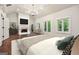 Serene main bedroom with a fireplace, French doors, and abundant natural light, creating a cozy retreat at 10765 Shallowford Rd, Roswell, GA 30075
