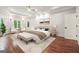 Spacious main bedroom with tray ceiling, accent lighting, and a cozy sitting area, perfect for relaxation at 10765 Shallowford Rd, Roswell, GA 30075