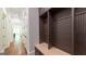 Hallway with mudroom featuring custom wooden cabinets and a bench seat at 10765 Shallowford Rd, Roswell, GA 30075