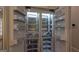 Open refrigerator showing shelving, door storage, and internal lighting at 10765 Shallowford Rd, Roswell, GA 30075