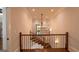 Staircase with hardwood floors and a decorative chandelier at 10765 Shallowford Rd, Roswell, GA 30075