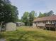 Large backyard with fences and green trees at 54 Crestwood Dr, Dallas, GA 30157