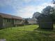 View of the fenced backyard of a home showing a well maintained yard, shed, and deck at 54 Crestwood Dr, Dallas, GA 30157