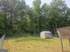 Backyard with a storage shed, surrounded by lots of trees at 54 Crestwood Dr, Dallas, GA 30157