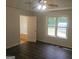 Bedroom featuring hardwood floors, a ceiling fan, and a view to an ensuite bathroom at 54 Crestwood Dr, Dallas, GA 30157