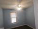 Comfortable bedroom featuring hardwood floors, a ceiling fan, and a large window at 54 Crestwood Dr, Dallas, GA 30157