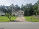 Charming two-story home with a two-car garage and long driveway nestled on a lush, green lawn at 54 Crestwood Dr, Dallas, GA 30157