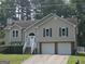Charming split-level home features a two-car garage, landscaped yard, and welcoming front porch at 54 Crestwood Dr, Dallas, GA 30157