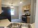 Charming kitchen features stainless steel appliances, classic cabinets, and modern light fixtures at 54 Crestwood Dr, Dallas, GA 30157