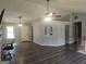 Open-concept living space with hardwood floors, fan, and views to the kitchen at 54 Crestwood Dr, Dallas, GA 30157