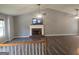 Bright living room featuring hardwood floors, a cozy fireplace, and a soaring vaulted ceiling at 54 Crestwood Dr, Dallas, GA 30157
