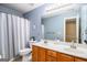 Bathroom featuring double sink vanity and a shower tub with curtain at 145 Windward Hls, Mcdonough, GA 30253