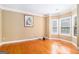 Cozy room with hardwood flooring, neutral paint, crown molding, and a bay window at 145 Windward Hls, Mcdonough, GA 30253