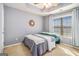 Cozy bedroom featuring a ceiling fan, carpet and a window providing natural light at 145 Windward Hls, Mcdonough, GA 30253