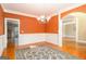 View of dining room with hardwood floors, bright orange walls, wainscoting, and a chandelier at 145 Windward Hls, Mcdonough, GA 30253