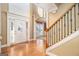Grand foyer with hardwood floors, high ceilings, decorative columns, and a staircase at 145 Windward Hls, Mcdonough, GA 30253
