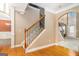 Inviting foyer featuring hardwood floors, staircase with decorative iron railing, and arched doorway to the living area at 145 Windward Hls, Mcdonough, GA 30253