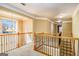 Upper hall featuring wood railing, neutral carpet and paint, and overhead lighting at 145 Windward Hls, Mcdonough, GA 30253