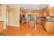 Spacious kitchen with wooden cabinetry, hardwood floors, stainless steel appliances, and central island at 145 Windward Hls, Mcdonough, GA 30253