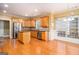 Open kitchen featuring wooden cabinets, hardwood floors, stainless steel appliances, and an island at 145 Windward Hls, Mcdonough, GA 30253