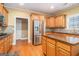 Well-appointed kitchen with wood cabinets, stainless steel appliances, and hardwood flooring at 145 Windward Hls, Mcdonough, GA 30253