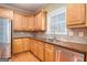 Kitchen with wooden cabinets, hardwood flooring, stainless steel appliances, and a double sink at 145 Windward Hls, Mcdonough, GA 30253