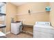 Functional laundry room with washer, dryer, shelving, and plenty of counter space at 145 Windward Hls, Mcdonough, GA 30253