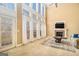 Bright living room featuring fireplace, tall windows with curtains, and neutral carpeting at 145 Windward Hls, Mcdonough, GA 30253