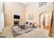 Spacious living room with a fireplace, high ceilings, and a large window providing natural light at 145 Windward Hls, Mcdonough, GA 30253