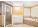 Main bathroom with white cabinets, stand-up shower, and soaking tub at 145 Windward Hls, Mcdonough, GA 30253