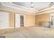 Primary bedroom with tray ceiling, ceiling fan, and ensuite bathroom access at 145 Windward Hls, Mcdonough, GA 30253