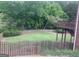 View of large backyard with a wooden fence and stairs leading to the deck at 2667 Hampton Park Dr, Marietta, GA 30062