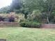 Fenced backyard featuring a lush green lawn and mature trees at 2667 Hampton Park Dr, Marietta, GA 30062
