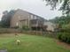Large backyard with a fenced perimeter, mature landscaping, and deck stairs at 2667 Hampton Park Dr, Marietta, GA 30062