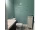Charming half bathroom with turquoise walls, white vanity, and decorative wall art at 2667 Hampton Park Dr, Marietta, GA 30062
