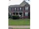 Charming two-story brick home with a classic design, black shutters, and well-maintained front yard at 2667 Hampton Park Dr, Marietta, GA 30062