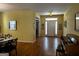 Open-concept living area showcases hardwood floors, light yellow walls, and access to other rooms at 2667 Hampton Park Dr, Marietta, GA 30062