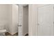 Neutral bathroom featuring a toilet, open closet, and full door at 325 Silver Moon Dr, Loganville, GA 30052