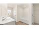 Bright bathroom featuring a double sink vanity, a tub, and a closet at 325 Silver Moon Dr, Loganville, GA 30052